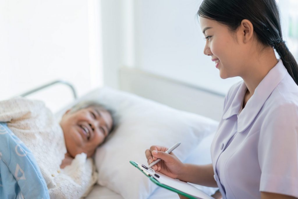 Nurse Happily Communicating with Patient
